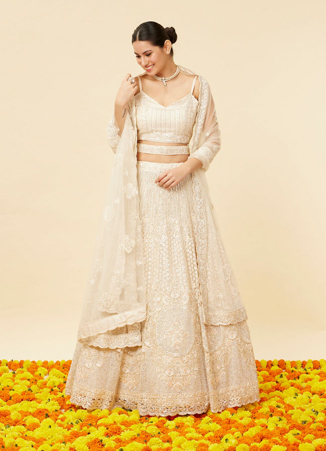 alt message - Mohey Women Ivory Cream Rhinestone and Sitara Embroidered Bridal Lehenga image number 1